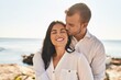 © Krakenimages.com - Man and woman couple smiling happy hugging each other standing at seaside
