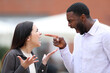 Angry man arguing and pointing to a woman