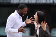 © PheelingsMedia - Interracial couple arguing in the street