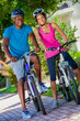 Healthy Afro American couple enjoying bike ride together