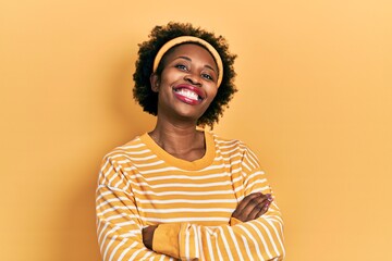 Wall Mural - Young african american woman wearing casual sweatshirt happy face smiling with crossed arms looking at the camera. positive person.