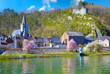 Dinant, Belgium - March 9. 2022: View Over River Meuse On Typical Small Belgian Village With Church