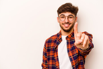 Young hispanic man isolated on white background showing number one with finger.