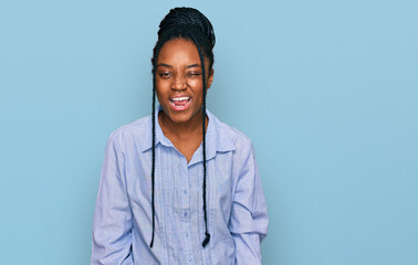 Sticker - Young african american woman wearing casual clothes winking looking at the camera with sexy expression, cheerful and happy face.