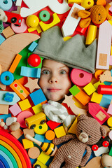 Child's face in the plenty of wooden toys