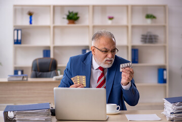 Wall Mural - Old male employee feeling bad at workplace