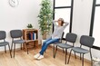 © Krakenimages.com - Young chinese woman listening to music sitting on chair at waiting room