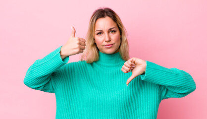 Wall Mural - pretty blonde woman feeling confused, clueless and unsure, weighting the good and bad in different options or choices