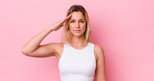 Pretty Blonde Woman Greeting The Camera With A Military Salute In An Act Of Honor And Patriotism, Showing Respect