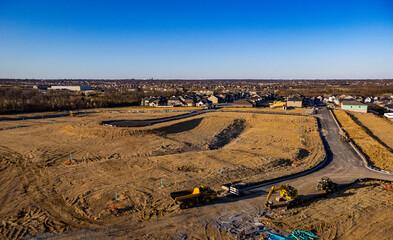 City expansion grounds with construction equipment on the foreground and city of Lexington downtown district in the distance on the horizon