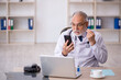 © Elnur - Old male doctor in telemedicine concept