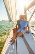 © Spotmatik - Loving retired couple sitting together on private yacht