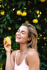 Wall Mural - beautiful woman with smooth skin with a lemon fruit in her hands