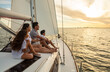 © Spotmatik - Hispanic family sailing on private yacht at sunset