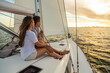© Spotmatik - Romantic young Hispanic couple sailing yacht at sunset