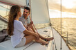 © Spotmatik - Attractive Hispanic couple relaxing on yacht at sunrise