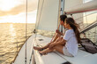 © Spotmatik - Outdoor adventures at sunrise for couple on yacht