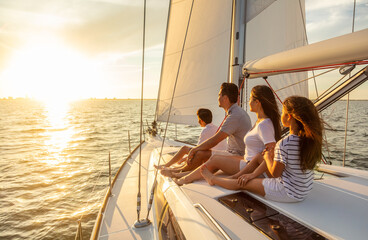 Wall Mural - Sailing at sunset Hispanic family enjoying carefree vacation