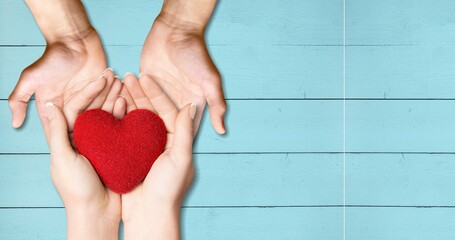 Wall Mural - Concept Happy Mother's Day or International Day of Families. Heart in the hands of daughter and mother