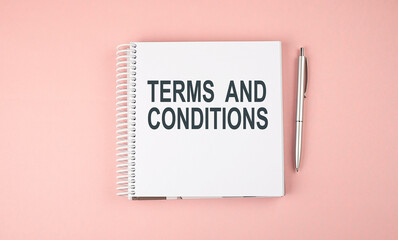 TERMS AND CONDITIONS text on notebook with pen on the pink background