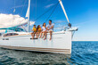 © Spotmatik - Happy Hispanic family relaxing together on private yacht