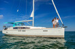 © Spotmatik - Latino family standing on yacht in tropical ocean