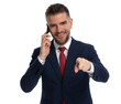 © Viorel Sima - businessman pointing at the camera and talking on the phone