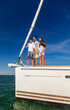 © Spotmatik - Successful young Latino family standing on private yacht