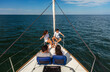 © Spotmatik - Young Hispanic family sitting together on private yacht