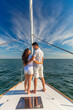 © Spotmatik - Latin American couple standing together on private yacht