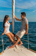 © Spotmatik - Travel loving Latino couple sitting together on yacht