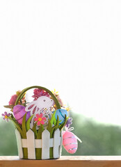 Wall Mural - Easter Bunny with eggs and flowers in basket, abstract light natural background. Easter Holiday. decorative festive composition. spring season. copy space