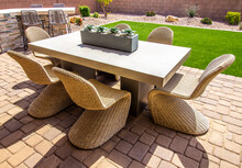 Rear Pavers Patio With Table And Six Unique Wicker Chairs
