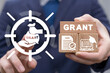 Concept of grants. Application grant. Businessman using virtual touchscreen and holding wooden blocks with grant conceptual presentation.