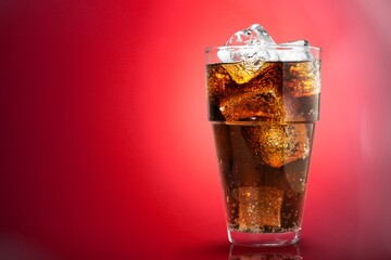 Sticker - caramel drink, no cola, with ice. Fresh cold sweet drink with ice cubes on red background.