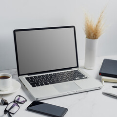 modern lap top template mock up on white and clean work desk with blank screen Workspace desk, laptop, coffee cup and pen. laptop mock up screen view. work from home concept