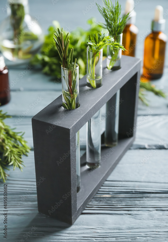 Test tubes with natural essential oils on table