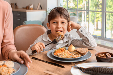 Wall Mural - Muslim little boy having breakfast. Celebration of Eid al-Fitr