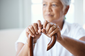 Canvas Print - Time to get up and go. Closeup shot of a senior woman holding her cane while sitting in the old age home.