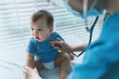 Asian Pediatrician with patient baby at pediatric clinic, Doctor using stethoscope for checking heart beat and lungs, Medical exam