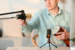 © Pixel-Shot - Young man with drum and modern microphones at home, closeup