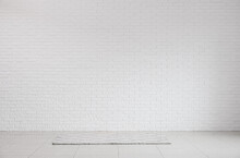 View Of White Brick Wall And Carpet In Big Room