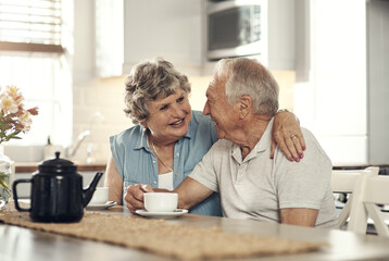 Canvas Print - Bonding over a cup of tea. Shot of a senior couple having breakfast together at home.