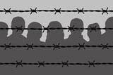Dark people silhouettes behind barbed wire fencing