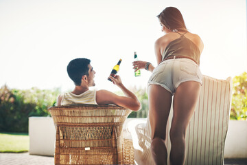 Poster - Cheers, babe. Rearview shot of an affectionate young couple cheersing while drinking beer on their patio.