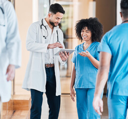 Wall Mural - digital diagnosis is faster diagnosis. shot of two young doctors using a tablet and having a discuss