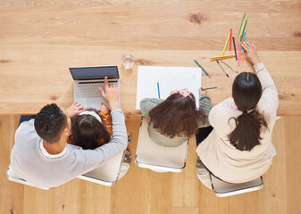 Wall Mural - Helping our children grow. Shot of two parents helping their children with their homework.