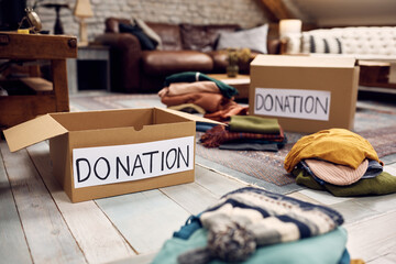 Wall Mural - Cardboard boxes with clothes for donation.