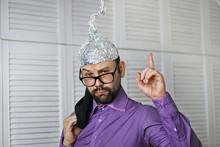Bearded Funny Man In A Cap Of Aluminum Foil. Concept Art Phobias.Conspiracy Theory. Conspiracy. Insanity.