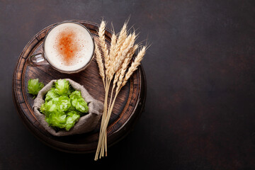 Wall Mural - Lager beer mug, hops and wheat on old wooden barrel